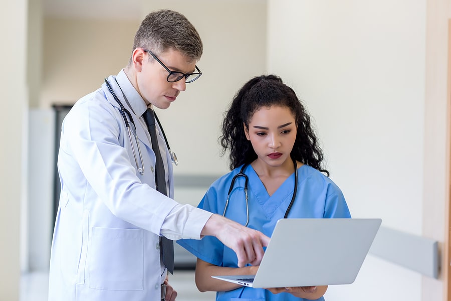 Clinicians In Uniform Standing And Looking Of Computer Monitor, Revenue Cycle Management in North Dakota