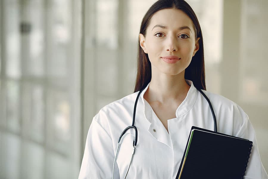 revenue-cycle-management_mesa_az Female doctor smiling to represent the positive difference of outsourcing revenue cycle management for providers in Mesa, Arizona