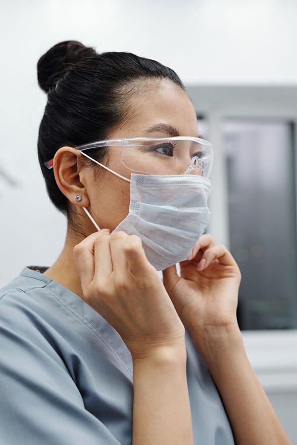 revenue-cycle-management_prescott_az Doctor putting on mask and other PPE to represent the revenue cycle management services for providers in Prescott, Arizona